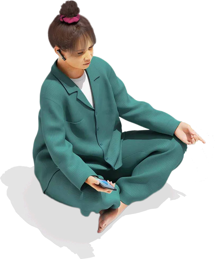 A person sitting cross-legged, looking at a phone